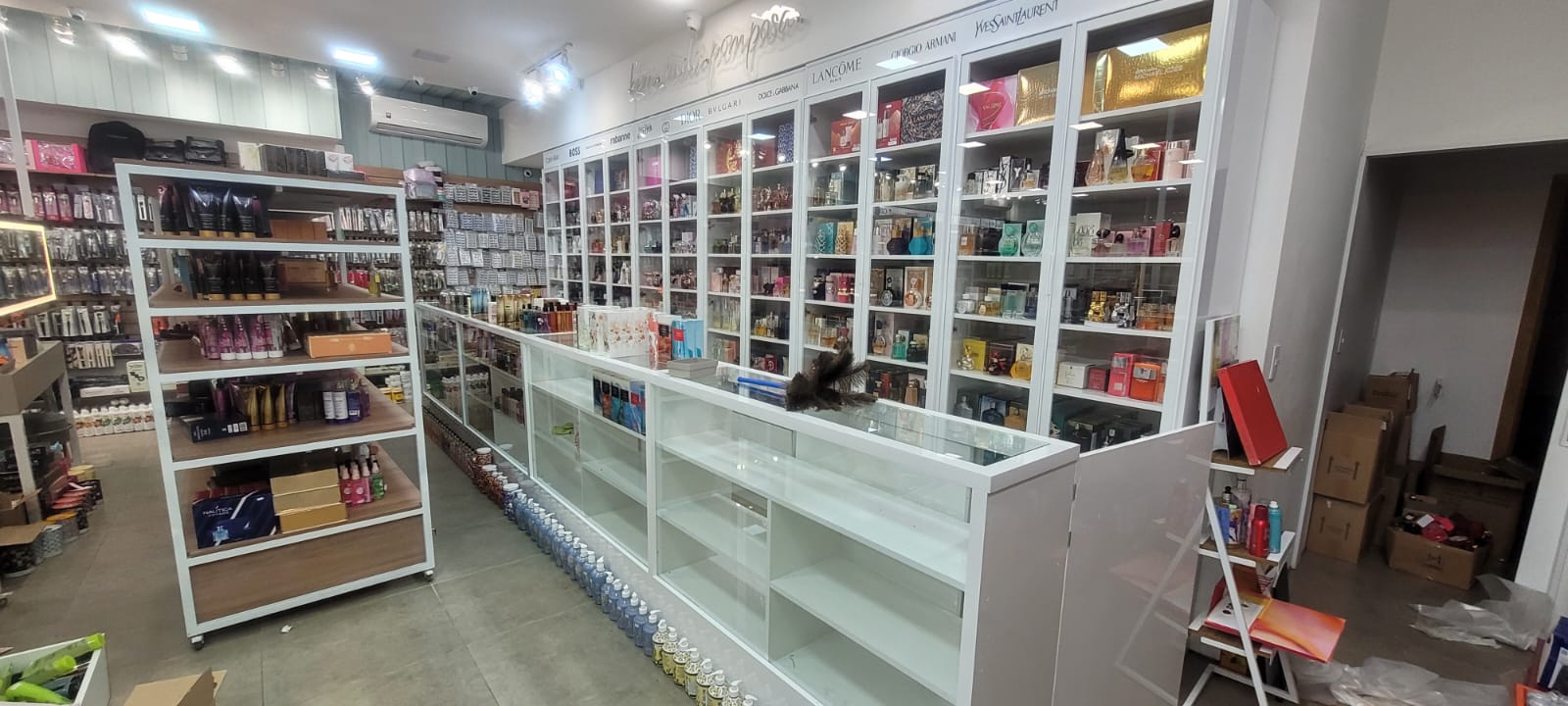 Perfumaria com parede de vitrines iluminadas
